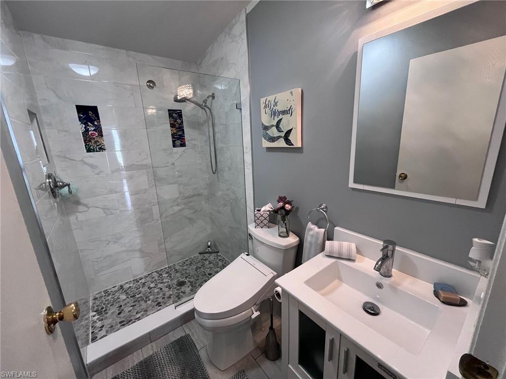 65 Turquoise Avenue, Unit 65T Naples, FL 34114 - Photo 20 of 34 a bathroom with a sink a toilet and shower