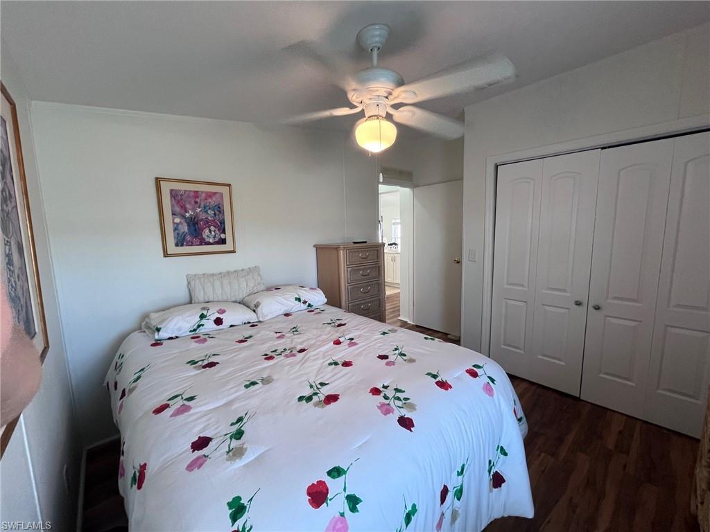 65 Turquoise Avenue, Unit 65T Naples, FL 34114 - Photo 22 of 34 a bedroom with a bed and a chandelier