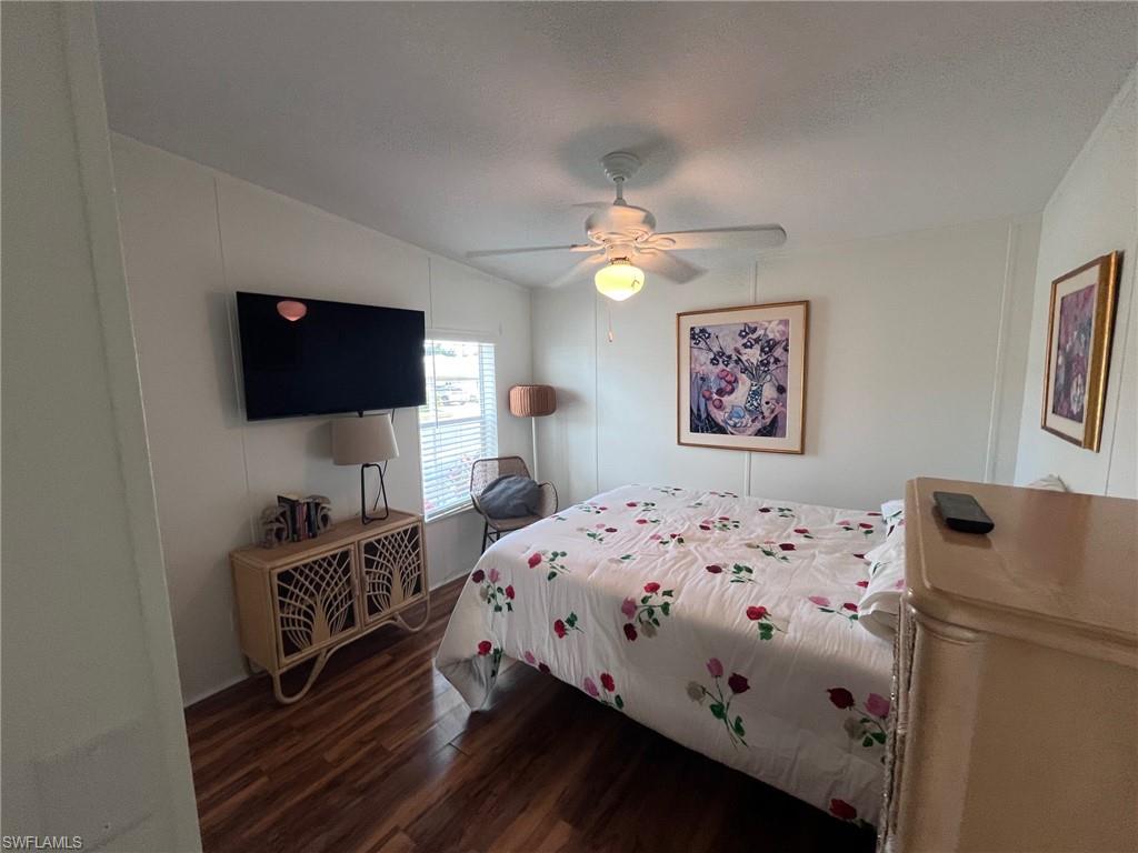 65 Turquoise Avenue, Unit 65T Naples, FL 34114 - Photo 23 of 34 a bedroom with a bed and a flat screen tv