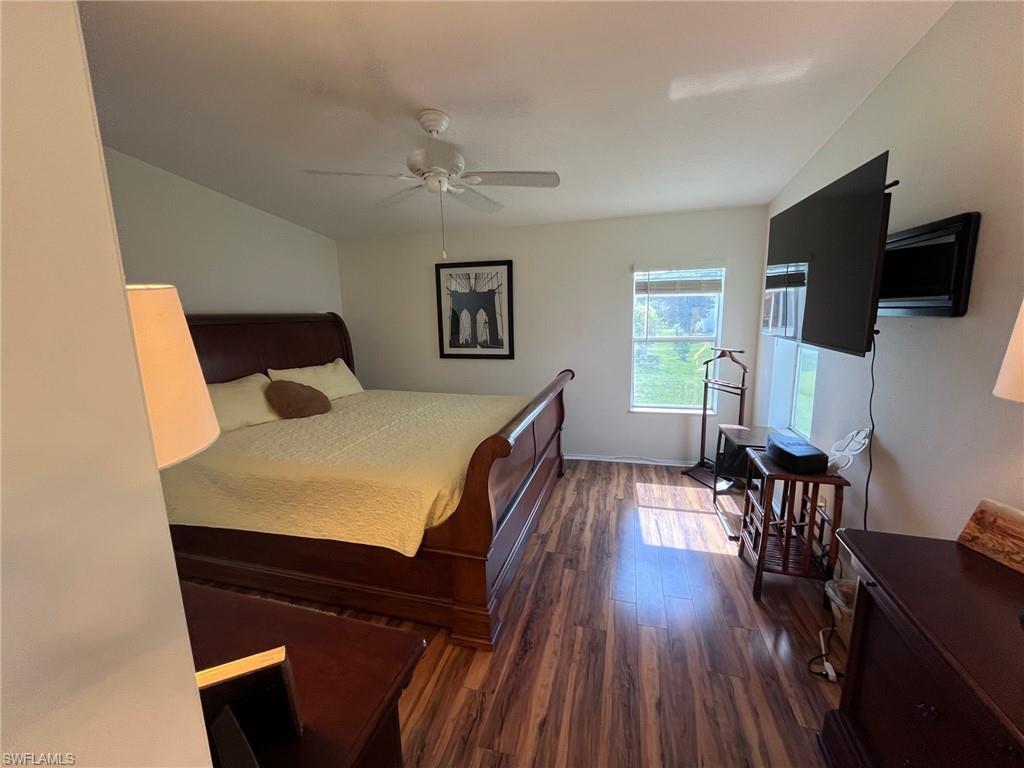 65 Turquoise Avenue, Unit 65T Naples, FL 34114 - Photo 26 of 34 a bedroom with a bed and a flat screen tv