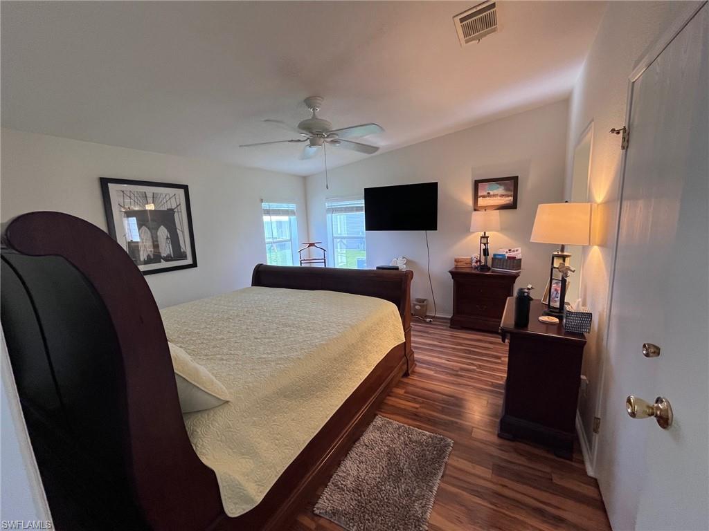 65 Turquoise Avenue, Unit 65T Naples, FL 34114 - Photo 27 of 34 a bed room with a bed and a television