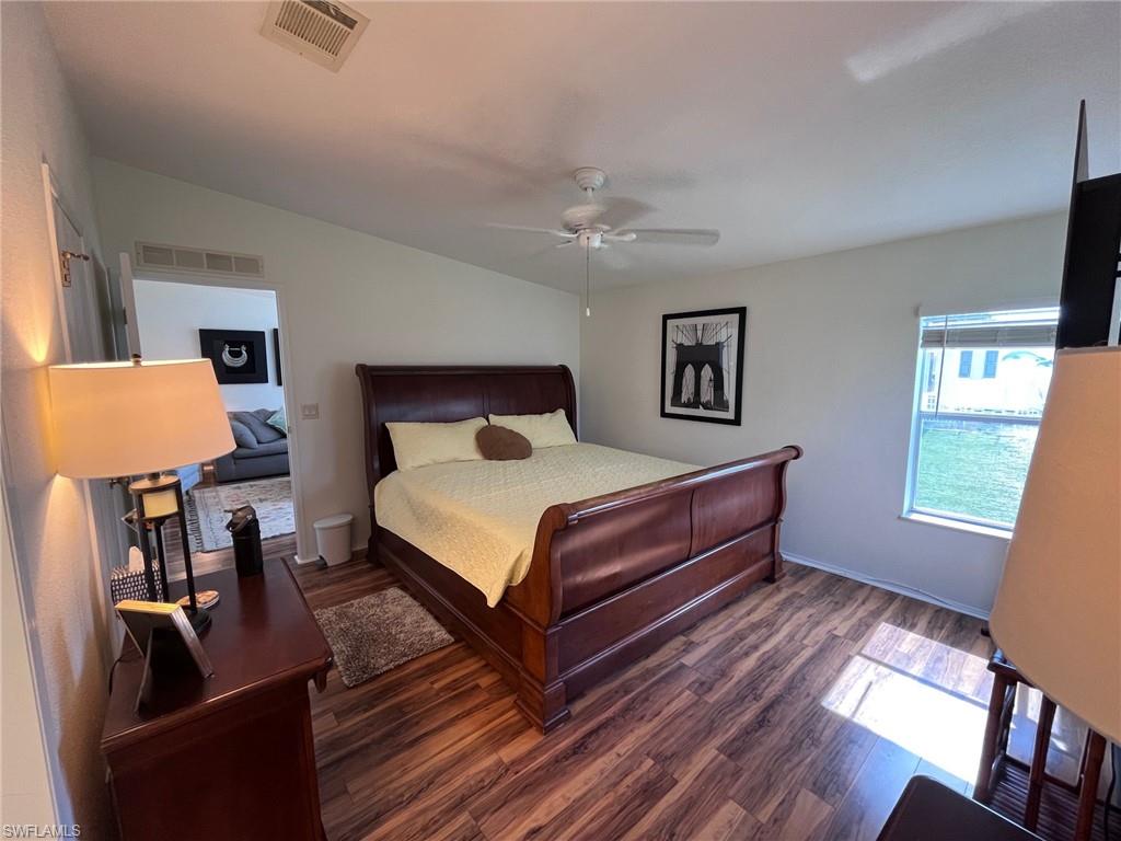 65 Turquoise Avenue, Unit 65T Naples, FL 34114 - Photo 28 of 34 a spacious bedroom with a bed and wooden floor