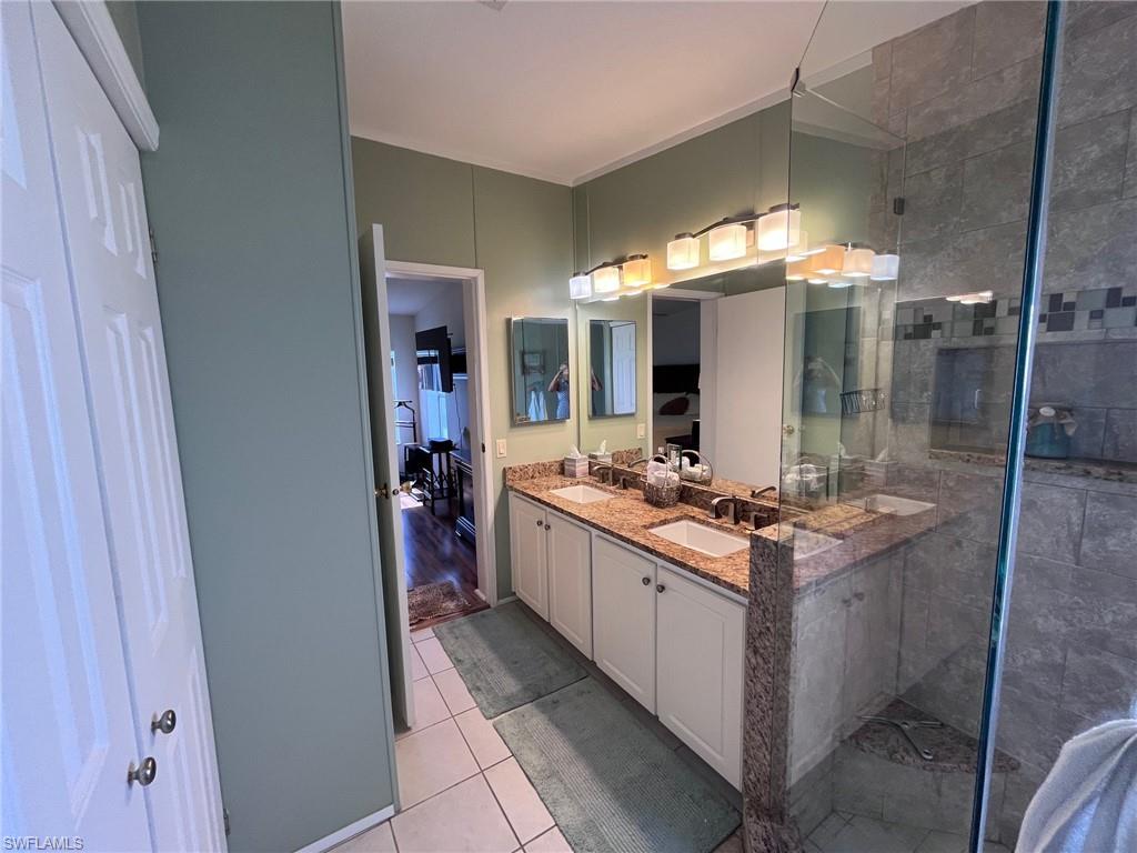 65 Turquoise Avenue, Unit 65T Naples, FL 34114 - Photo 29 of 34 a kitchen with a stove and a sink