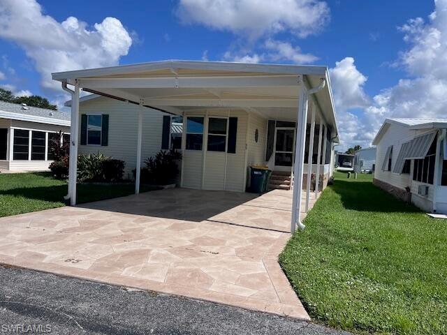 65 Turquoise Avenue, Unit 65T Naples, FL 34114 - Photo 3 of 34 a front view of a house with a yard