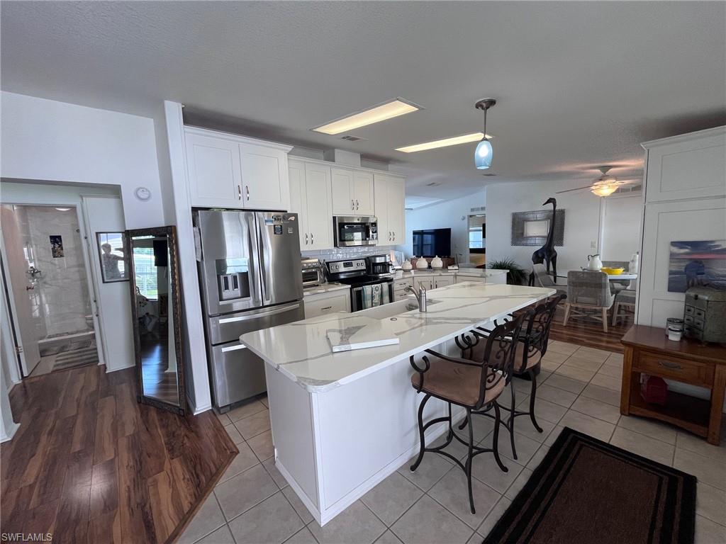 65 Turquoise Avenue, Unit 65T Naples, FL 34114 - Photo 7 of 34 a large kitchen with a table and chairs