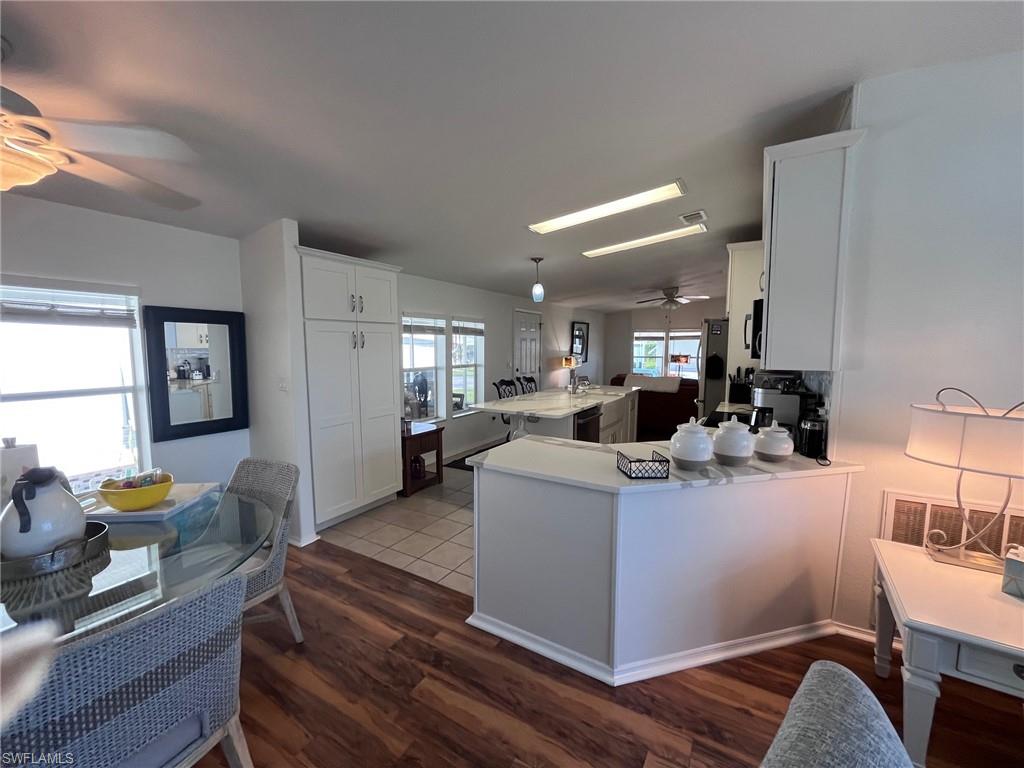 65 Turquoise Avenue, Unit 65T Naples, FL 34114 - Photo 8 of 34 a view of kitchen with kitchen island stainless steel appliances refrigerator stove dining table and chairs