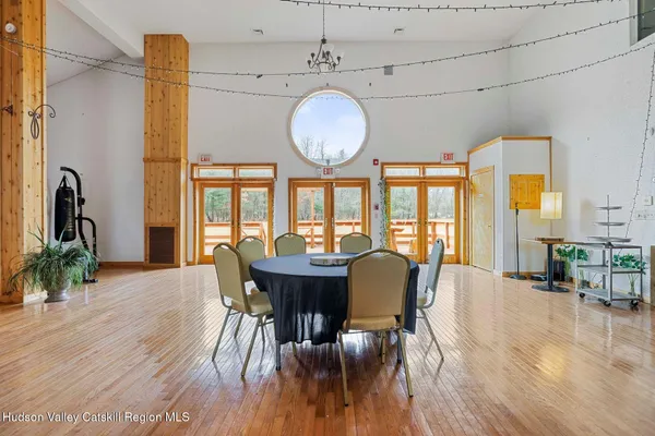 a bedroom with a large bed and a chandelier