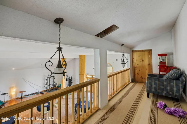 a room with gym equipment and view of living room