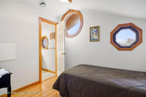 a view of a balcony with chairs and wooden floor