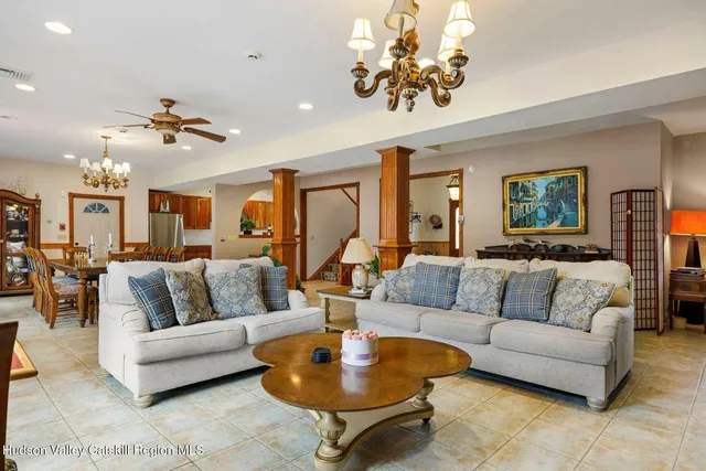 a large dining space with furniture a chandelier and window