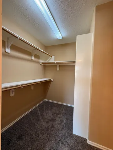 a spacious bathroom with a tub shower and mirror
