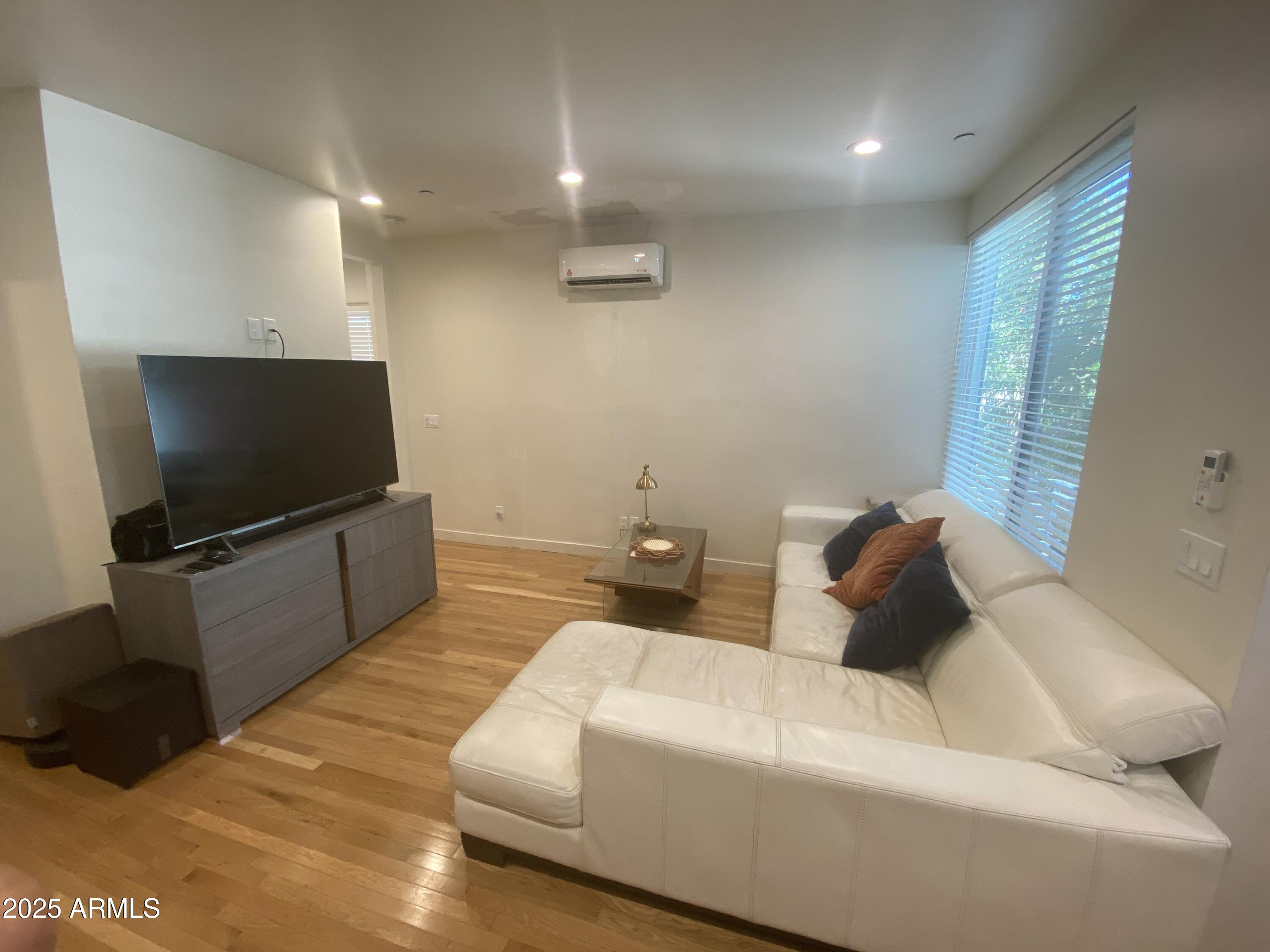 528 West Culver Street, Unit B Phoenix, AZ 85003 - Photo 5 of 7 a living room with furniture and a flat screen tv