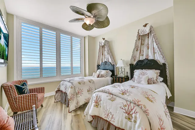 a bedroom with bed and a chandelier