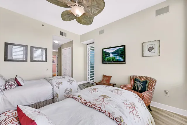 a bathroom with a granite countertop sink a toilet and a shower curtain
