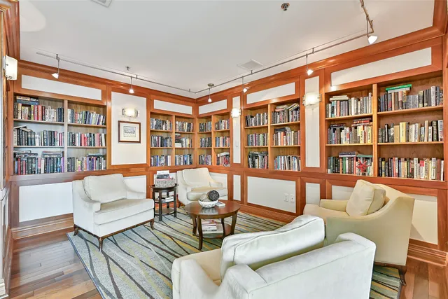 a living room with game table tennis table and arcade game machine