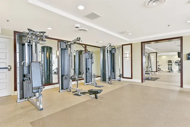a dining room with furniture and a floor to ceiling window