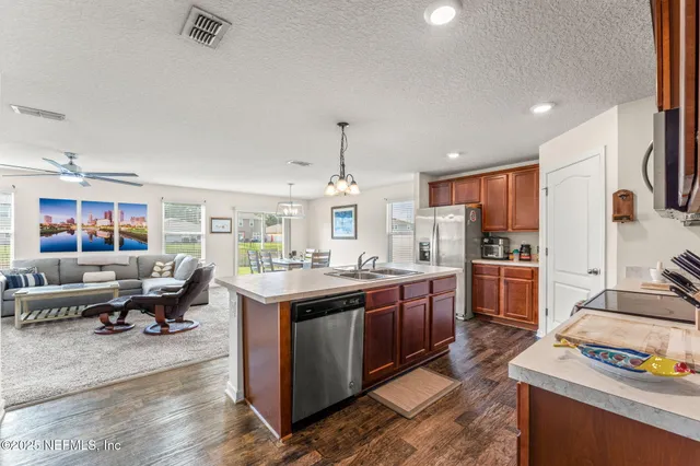 a kitchen with stainless steel appliances granite countertop a lot of counter space and a sink