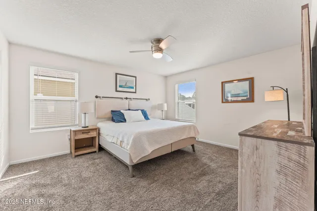 a bedroom with a bed dresser and a window