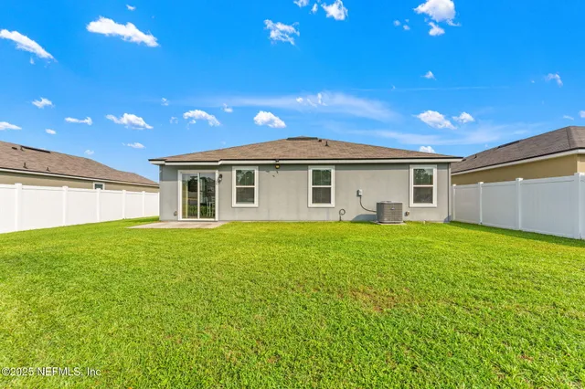 a backyard of a house with lots of green space