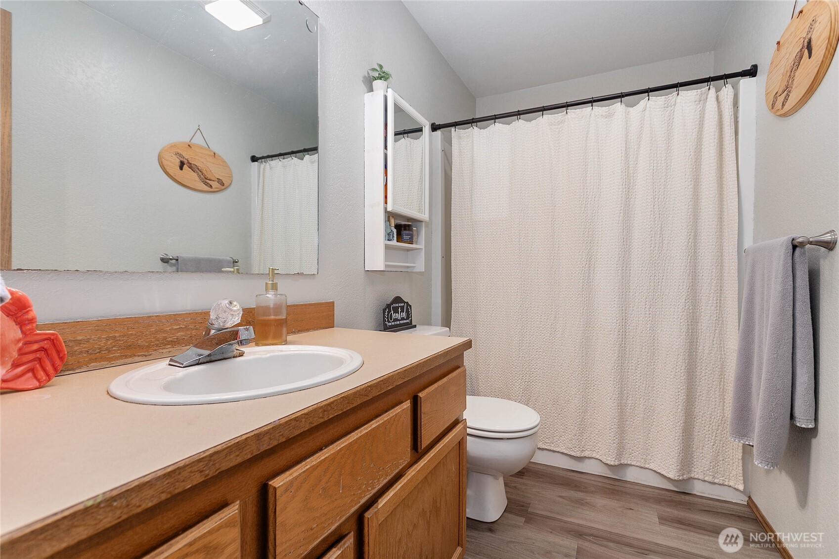 119 North 34th Street Bellingham, WA 98225 - Photo 12 of 21 a bathroom with a sink a toilet and a mirror