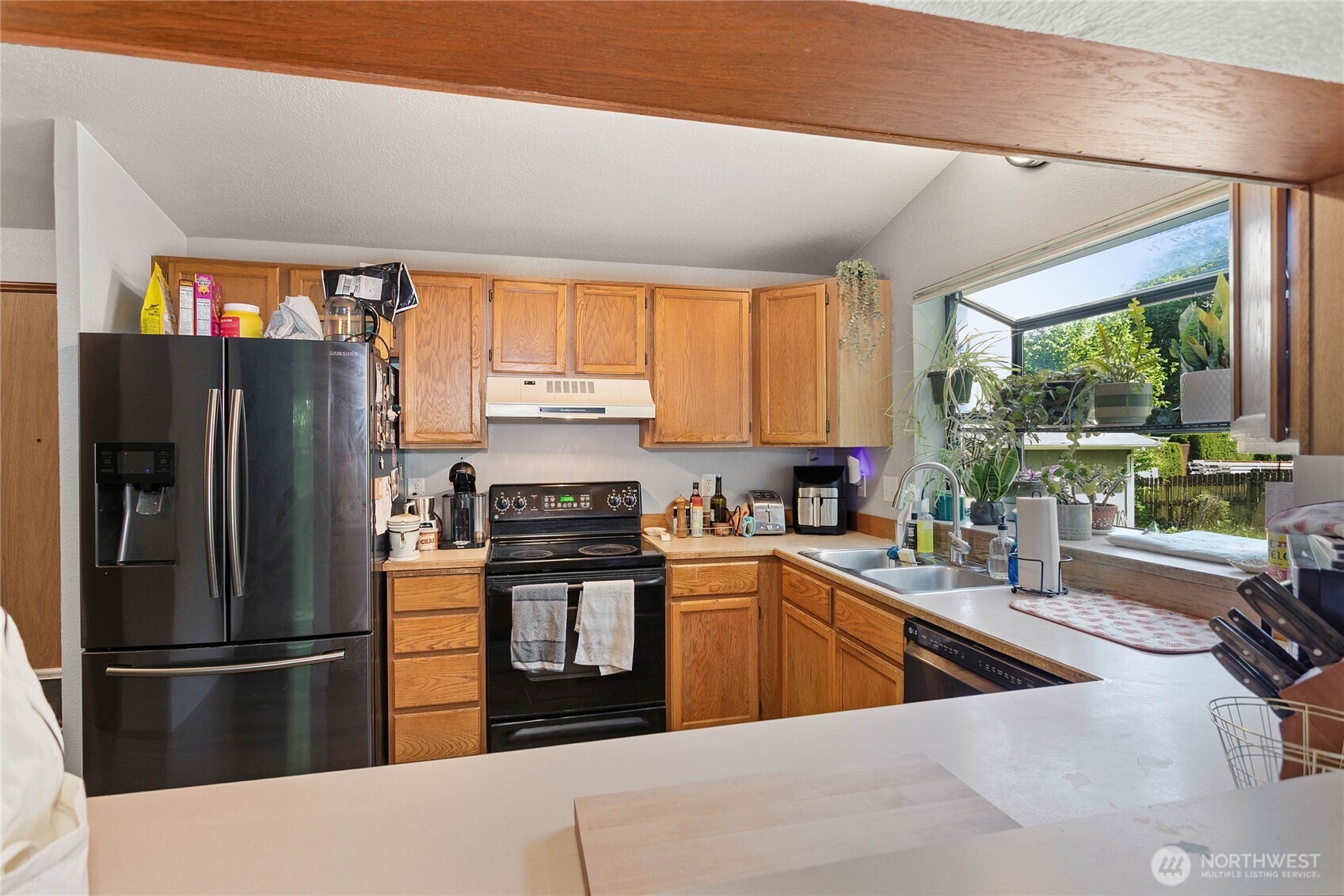 119 North 34th Street Bellingham, WA 98225 - Photo 9 of 21 a kitchen with stainless steel appliances granite countertop a refrigerator a sink a stove and white cabinets with wooden floor
