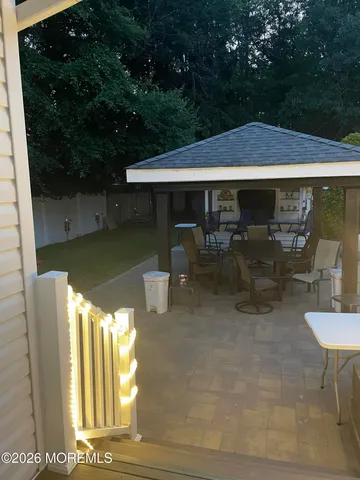 a backyard of a house with yard barbeque oven and outdoor seating