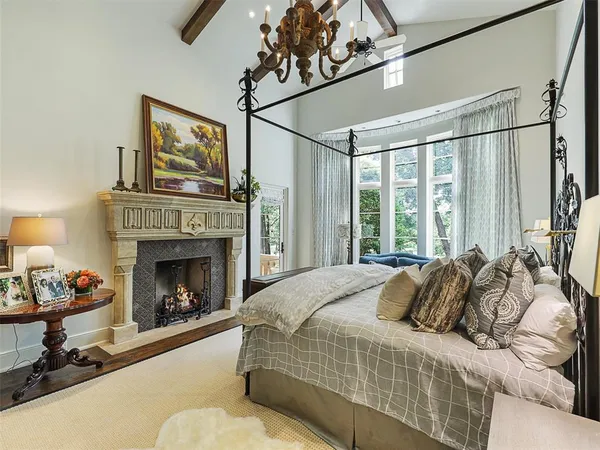 a bedroom with a bed and a fireplace