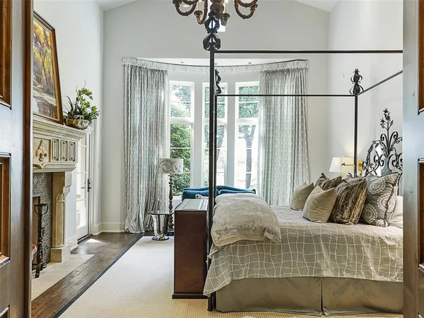 a bedroom with a bed and glass windows