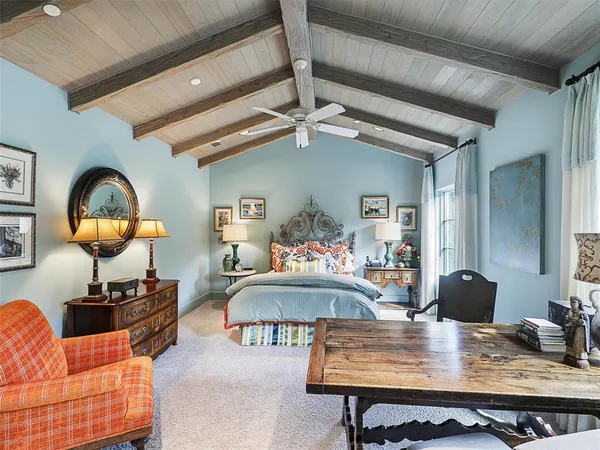 a living room with furniture a rug and a chandelier