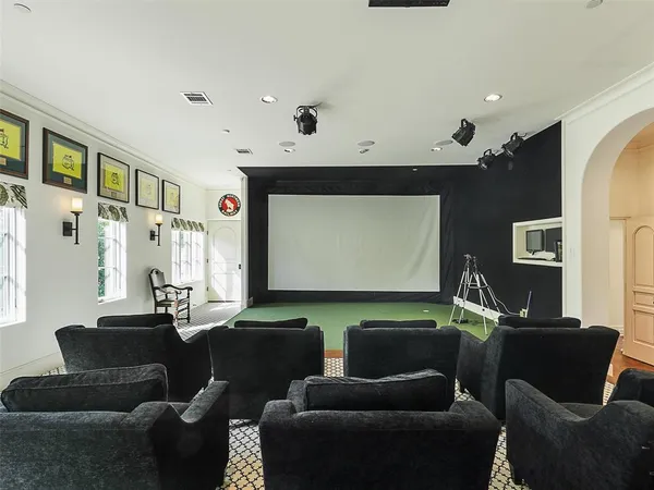 a media room with lots of chairs and a projector screen
