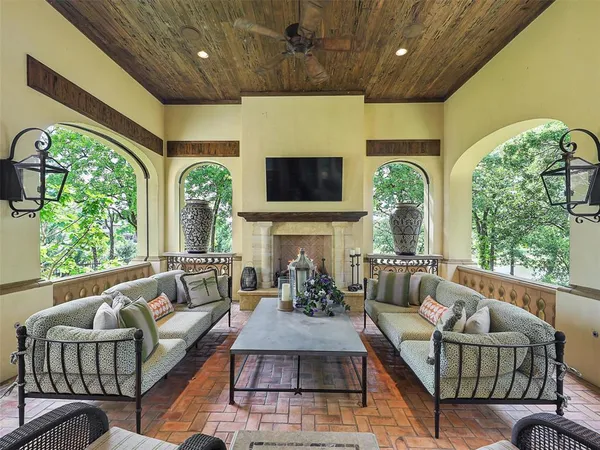 a living room with fireplace furniture and a large window
