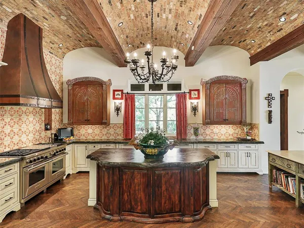 a kitchen with stainless steel appliances granite countertop a stove a sink dishwasher and a wooden cabinets