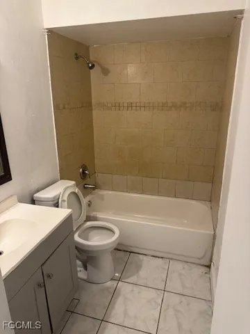 a bath room with a toilet and a bath tub