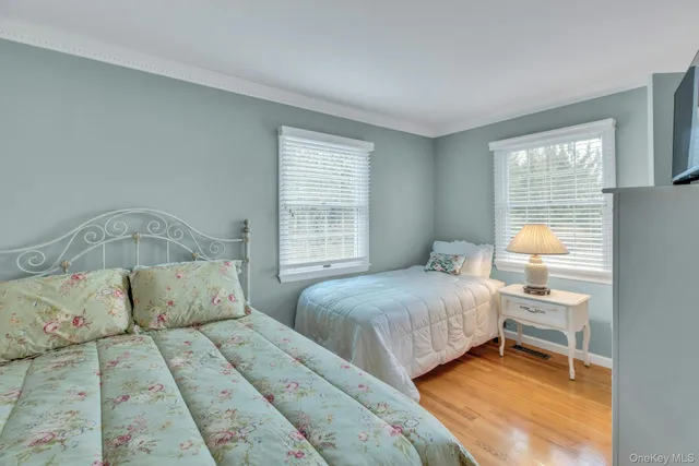 a bedroom with two beds and a window