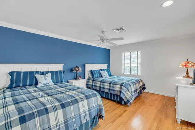 a bedroom with two beds and a chandelier