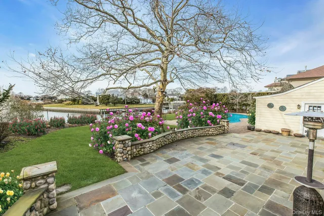 a front view of a house with a yard and potted plants