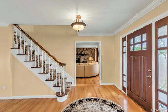 a view of entryway and hall with wooden floor