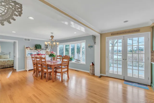 a dining room with furniture window and wooden floor