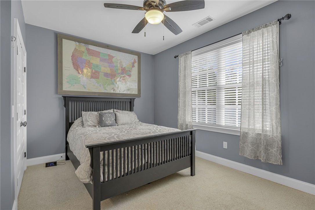 233 Bowen Drive Anderson, SC 29621 - Photo 26 of 50 An additional bedroom ,features an adjoining bath, carpeted floors and ample natural light, perfect for relaxation.