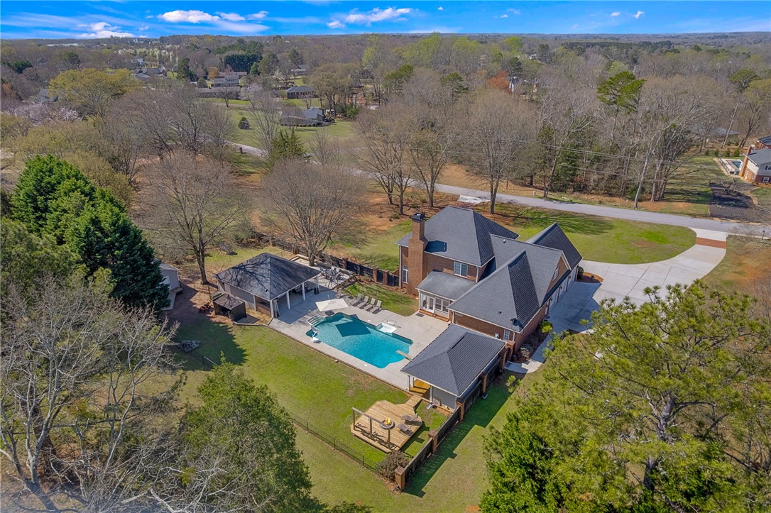 233 Bowen Drive Anderson, SC 29621 - Photo 45 of 50 An aerial perspective reveals a private pool area with an inviting outdoor fire pit and large pavilion.