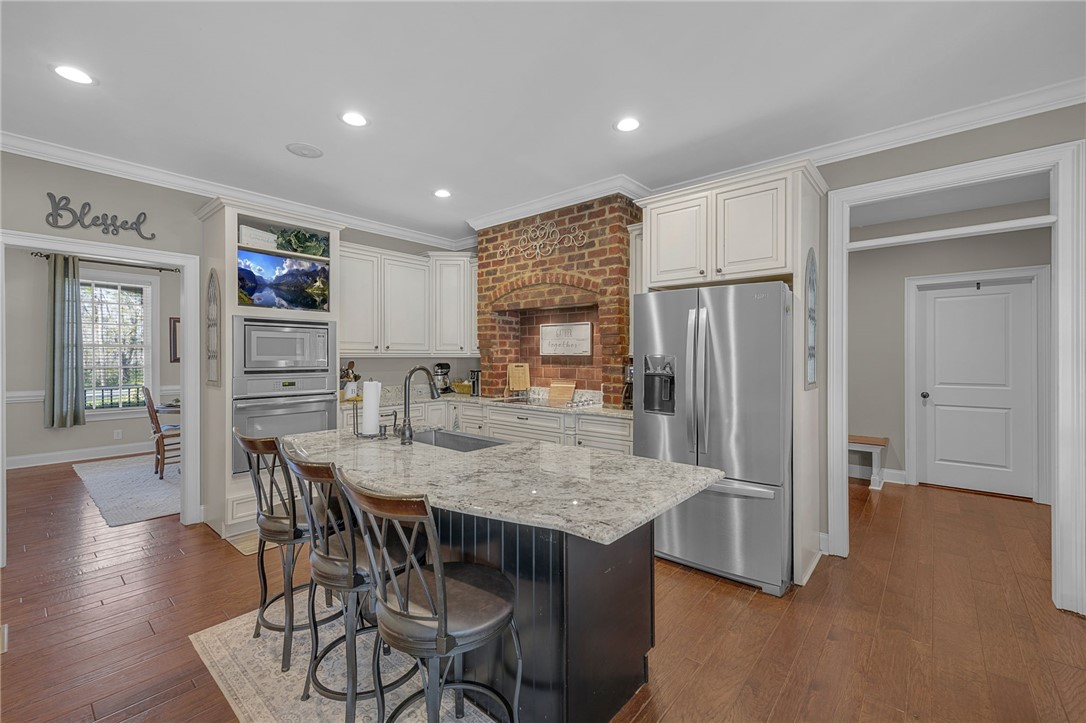 233 Bowen Drive Anderson, SC 29621 - Photo 8 of 50 This kitchen features a spacious island with seating and modern stainless steel appliances.