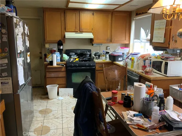 a kitchen with a sink appliances and cabinets