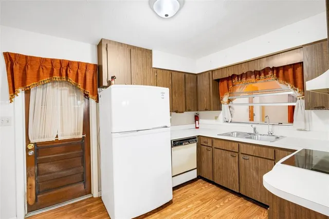 a view of a kitchen with a sink and dishwasher