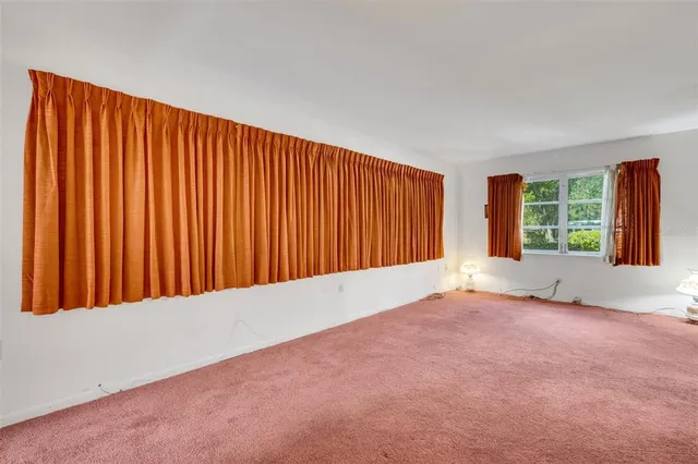 a view of an empty room and closet area