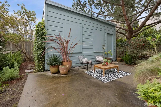 a backyard of a house with fire pit and outdoor seating