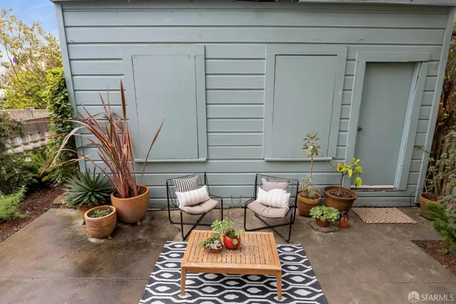 a backyard of a house with outdoor seating