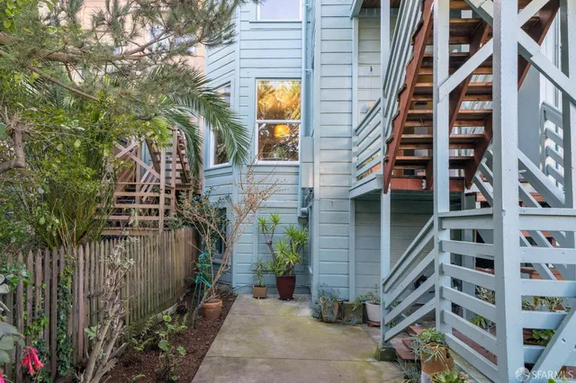 a front view of a building with a garden