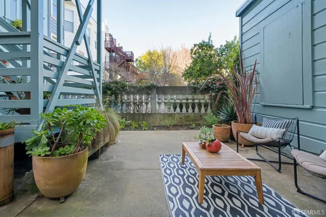 a view of a patio with couches and potted plants