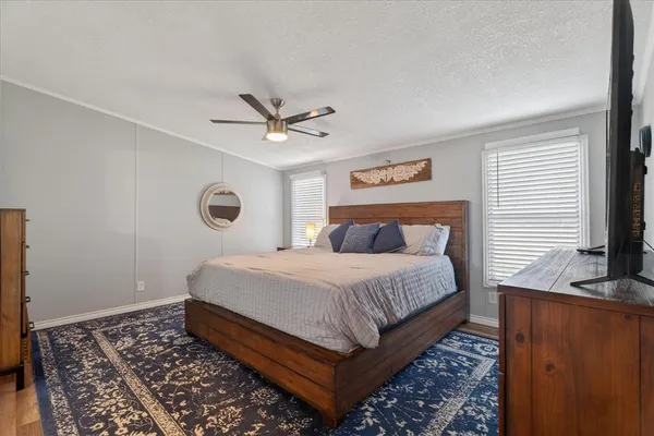 a bedroom with a large bed and a window