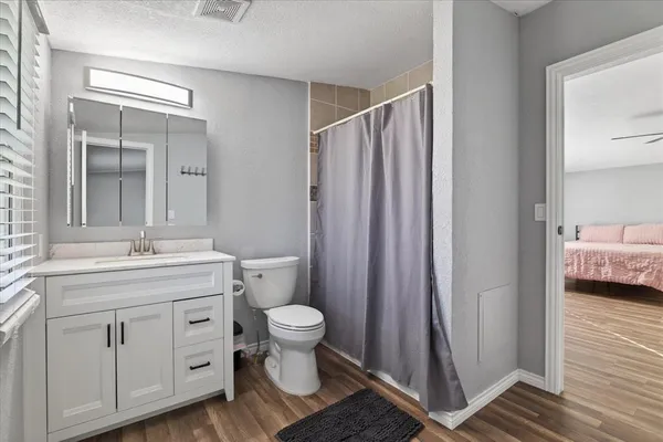 a bathroom with a sink toilet and shower
